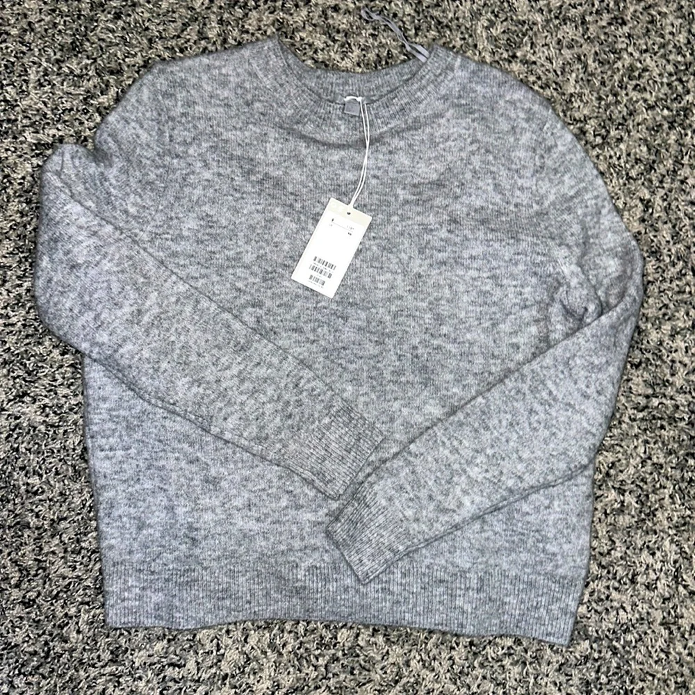 NWT. Woman’s COS grey sweater. With bow fold on back. Size XS.